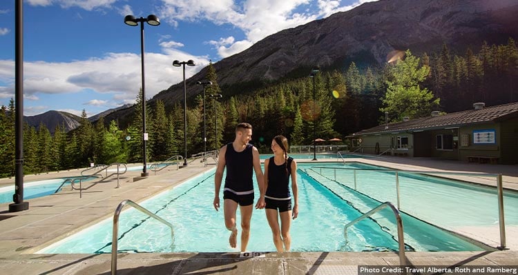 A couple exits the hot pool in the summer season.