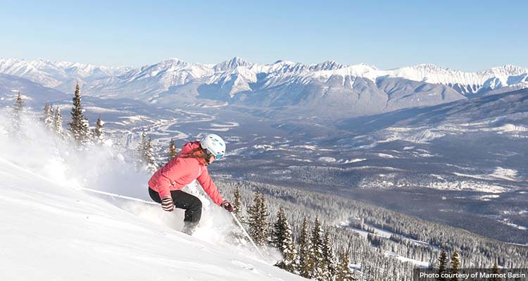 A skiier is alone on a snowy mountain