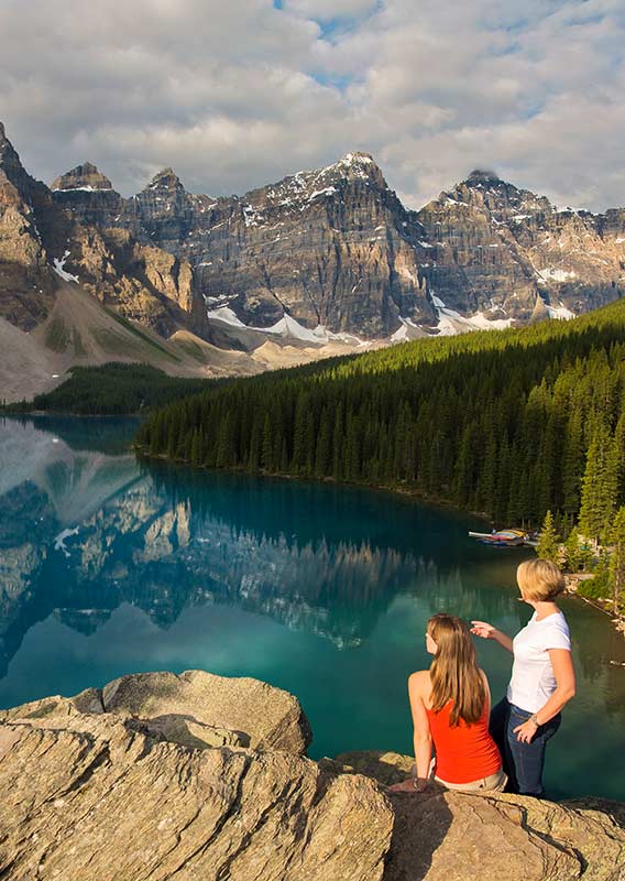 Two people on a clif overlooking a lake