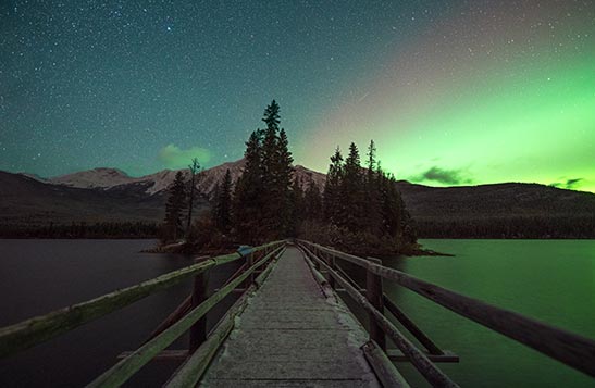 Green aurora is seen in the night sky above Pyramid Island.