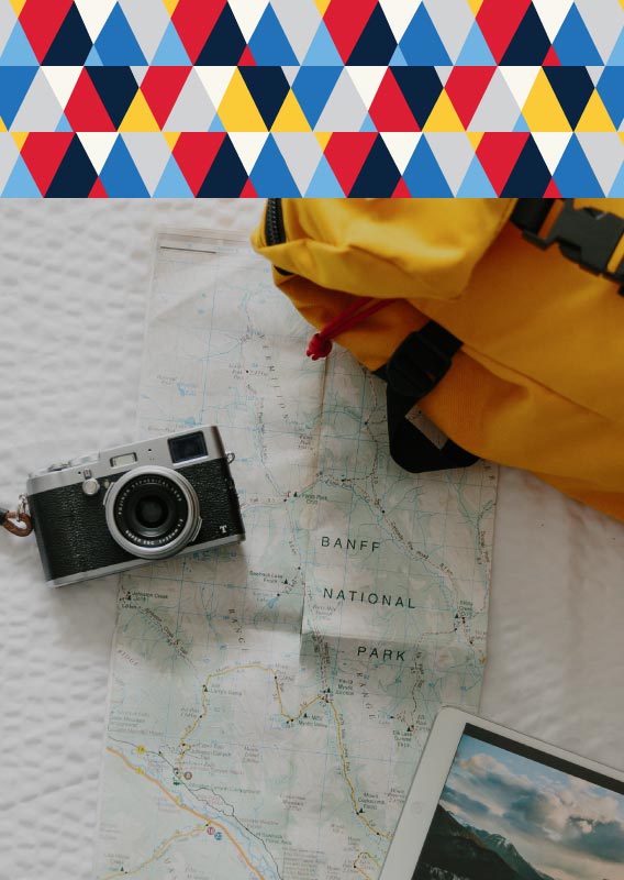 A camera, paper map and yellow backpack.