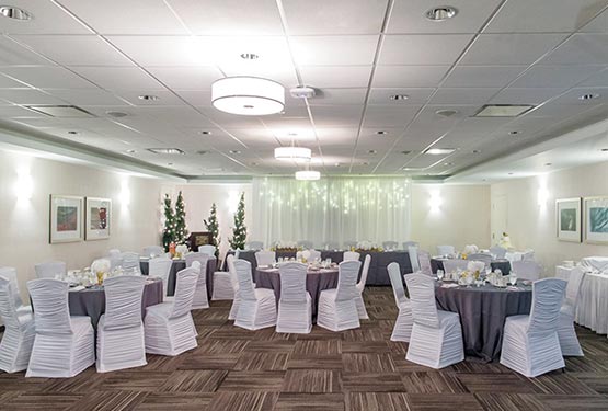 A room set up with round tables for a wedding.