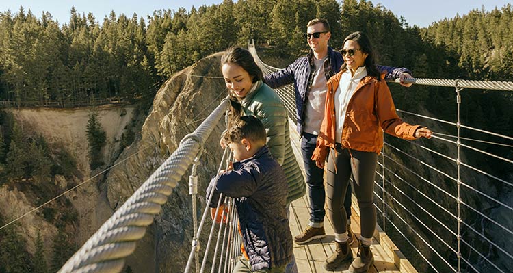 A family of four enjoying the sunshine and view at Golden Sky Bridge