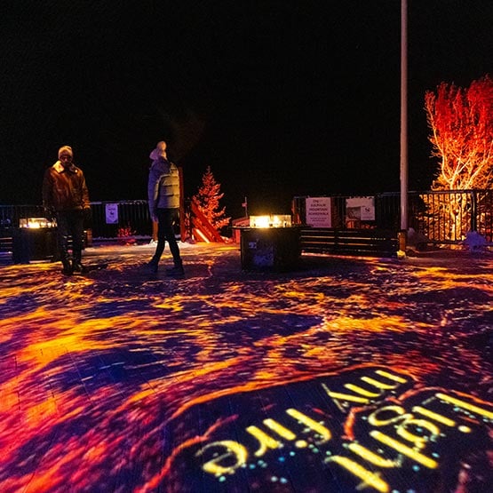 Guests walk around a lit up patio.