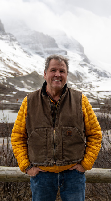 Sean Wall posing in front of a mountain at Columbia Icefield