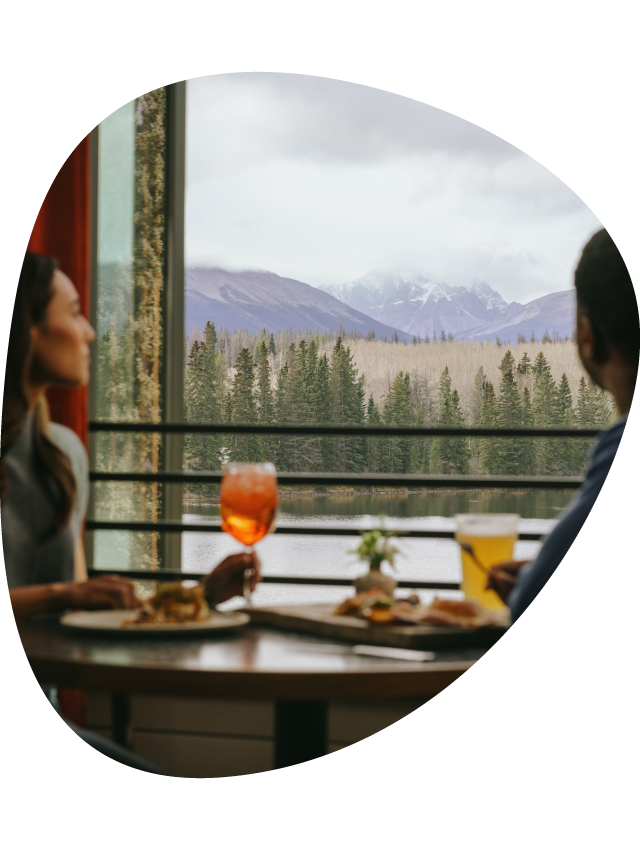 A couple dine at Aalto while looking out a window to Pyramid Lake.