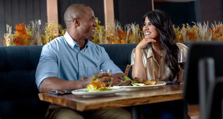 Couple smiling while dining at a table