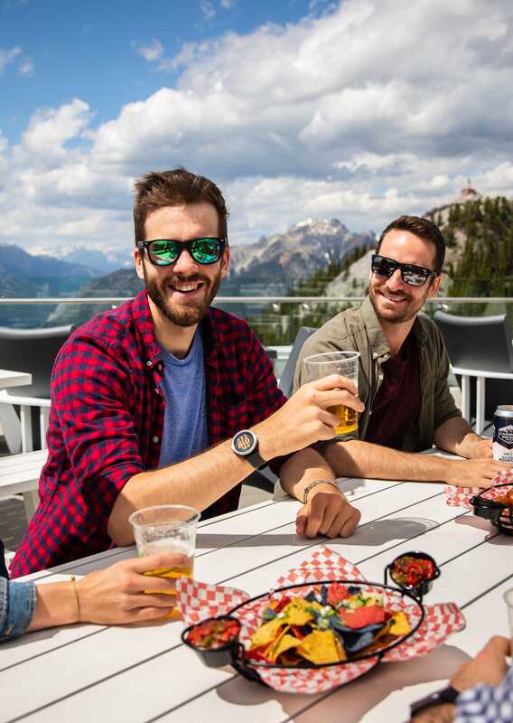 Friends dining on the patio at Banff Gondola