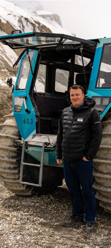 Jon Brennan standing with Ice Odyssey vehicle at Columbia Icefield