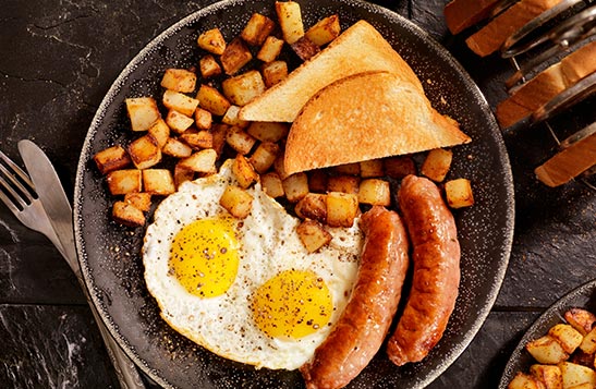 Breakfast food on a plate from above.