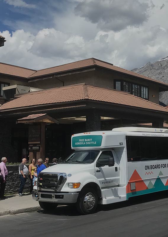 A shuttle bus picks up guests from a hotel.