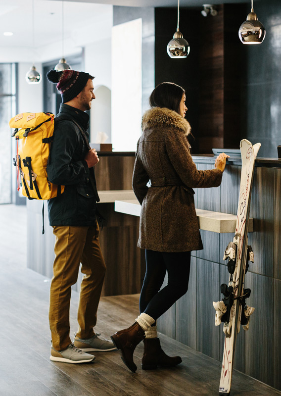 Two guests checking in at the Elk & Avenue hotel