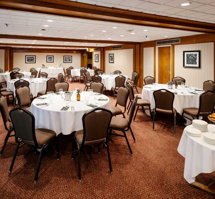 A banquet room with round dining tables.