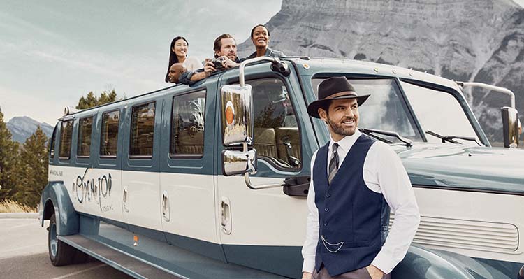 Guests aboard an Open Top Touring Bus take in the view