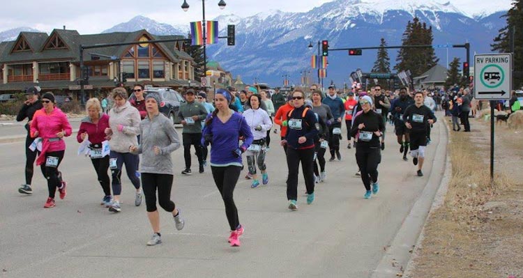 A group of runners together on a road.