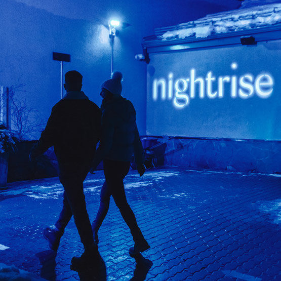 Two people walking together at Nightrise event