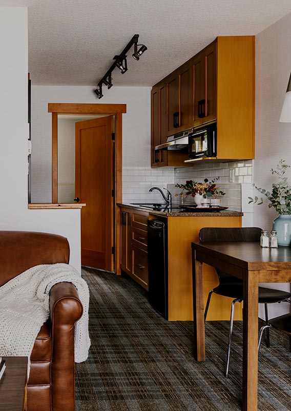A hotel room kitchen and living area.