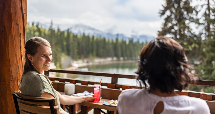 Two people dining on the patio at Aalto, looking out to Pyramid Lake