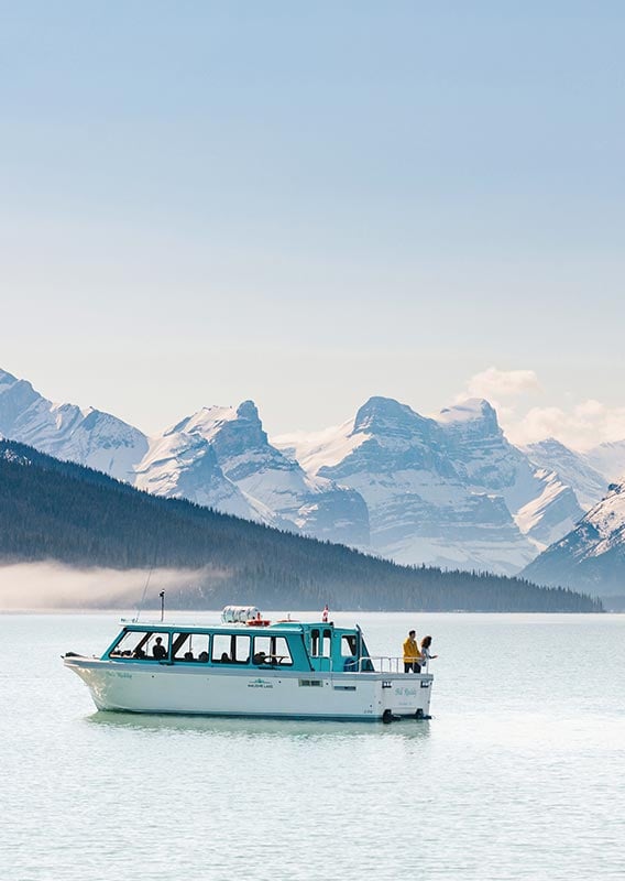 Maligne Lake Cruise boat on the lake with a mountain view