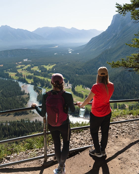 Two people taking in the Mountain View during a hike