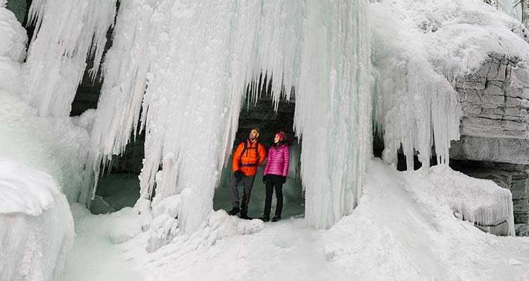 Two people inside the Maligne Canyon Icewalks.