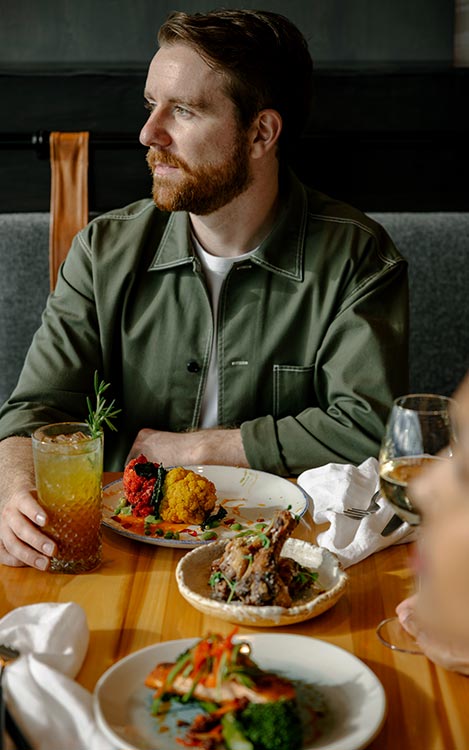 A man sits at a dinner table at Sky Bistro.