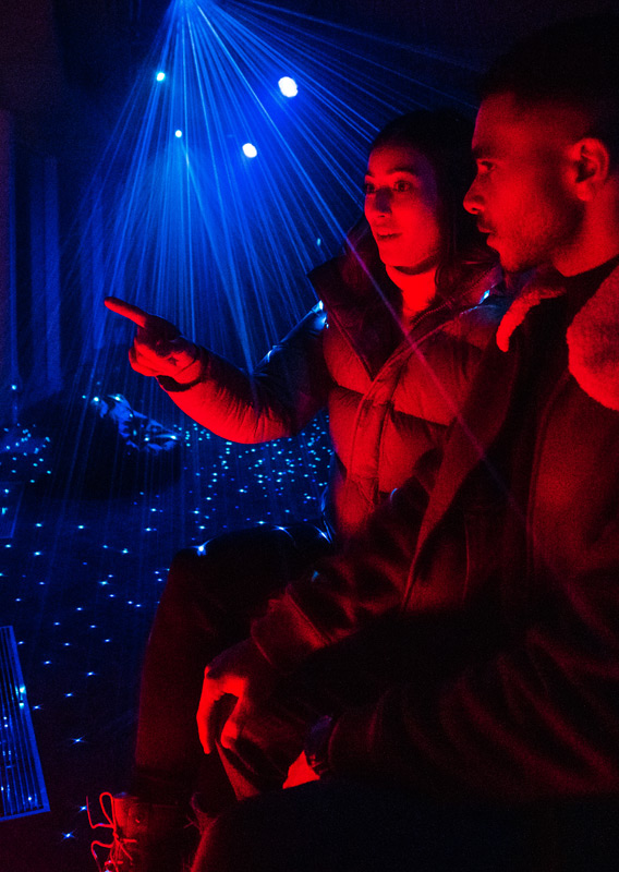 A couple viewing the displays at the Banff Gondola Nightrise event
