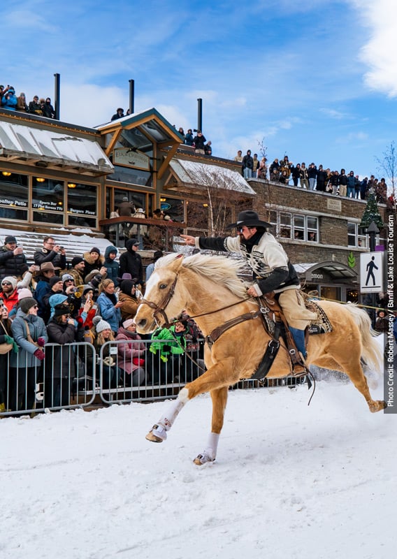 Two people participating in a skijoring event on Banff Avenue