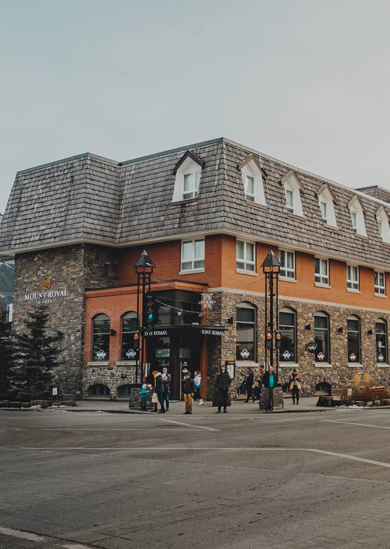 The exterior of a hotel at a street corner.