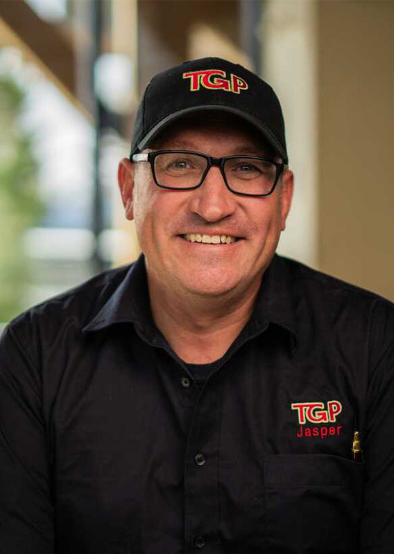 A portrait of Will Baart, wearing a TGP shirt and hat.