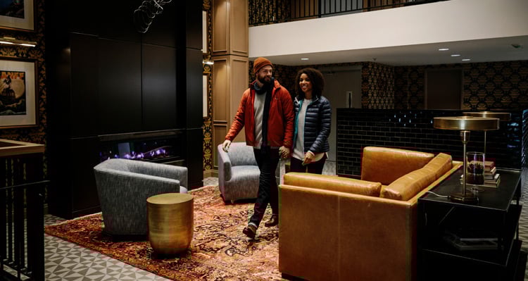 Two people walking through the lobby of the Mount Royal Hotel