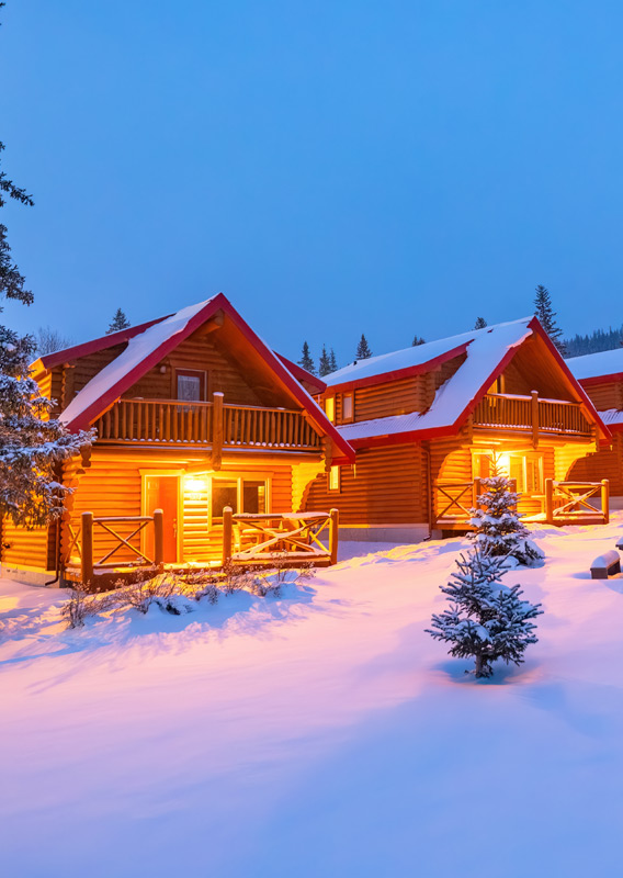 The Miette Mountain Cabins lit up at night during the winter