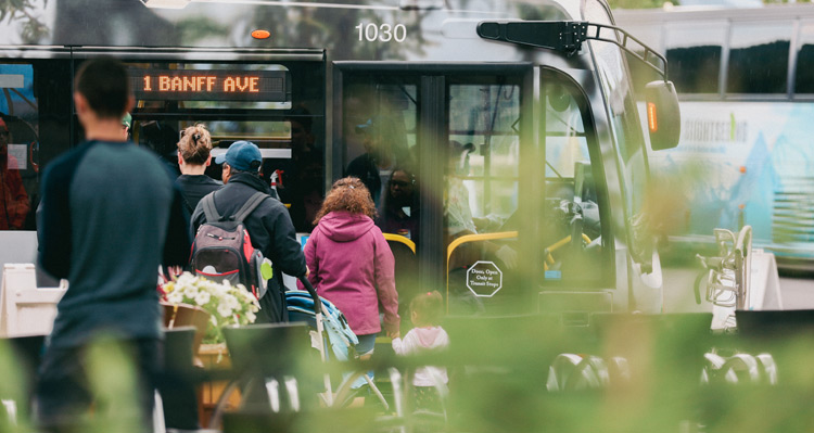 People lined up at the #1 Banff Avenue bus.