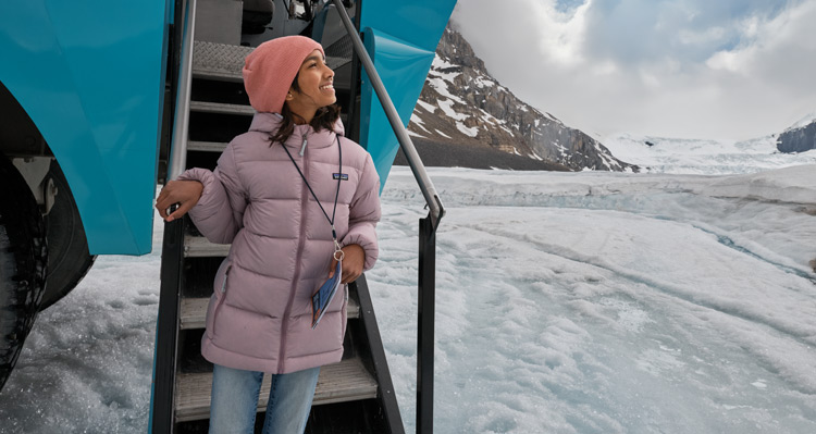A kid exiting the Columbia Icefield Adventure EV on Athabasca Glacier at the Columbia Icefield.