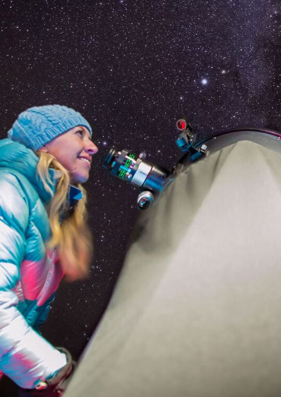 A person looking at the stars through a telescope at the Jasper Planetarium