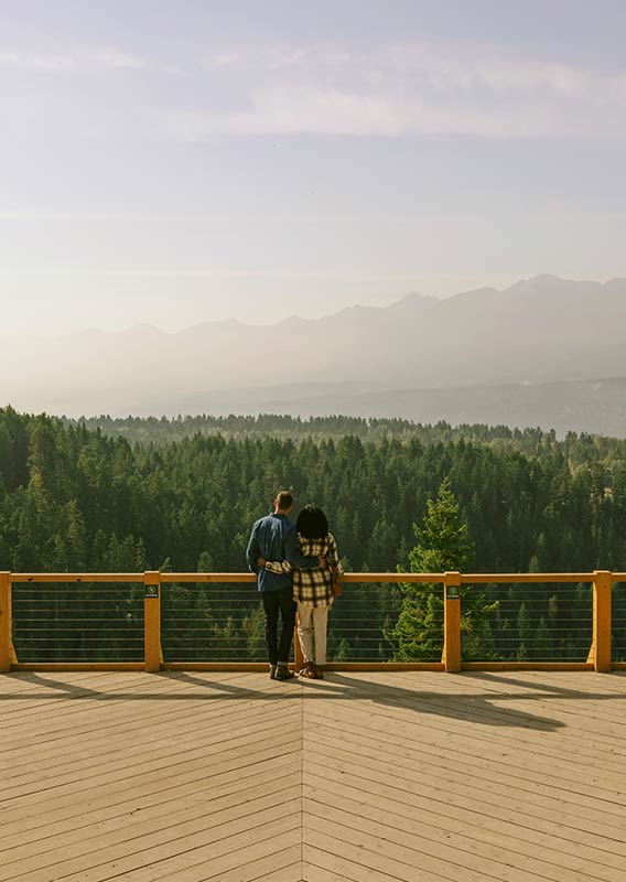 A couple stand at a lookout point at Golden Skybridge.