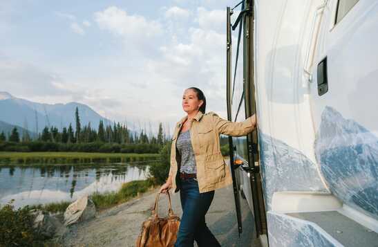 A woman steps off a Brewster Express bus.