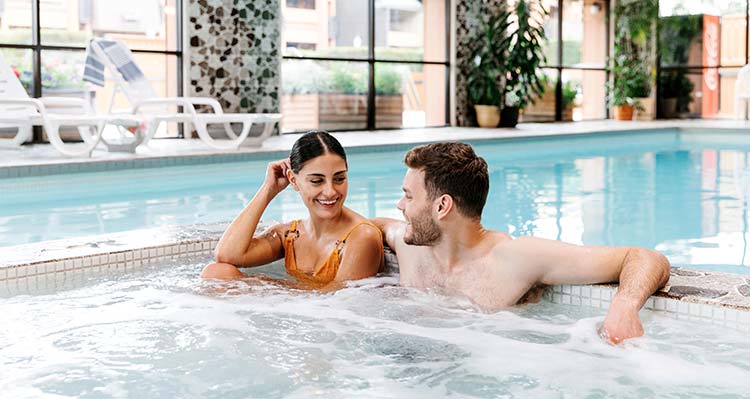 A man and woman in the hot tub at Marmot Lodge.