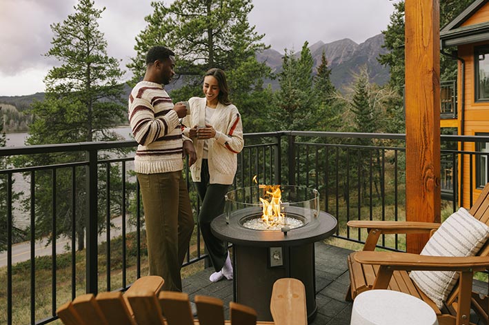 Two people standing on an outside balcony.