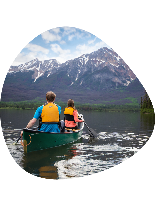 Two canoeists on a calm lake.