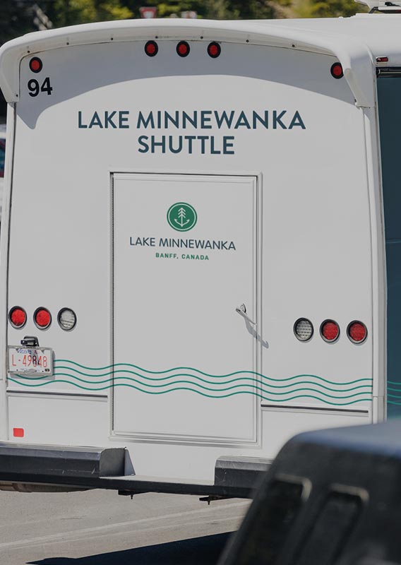 A small shuttle bus in a parking lot.
