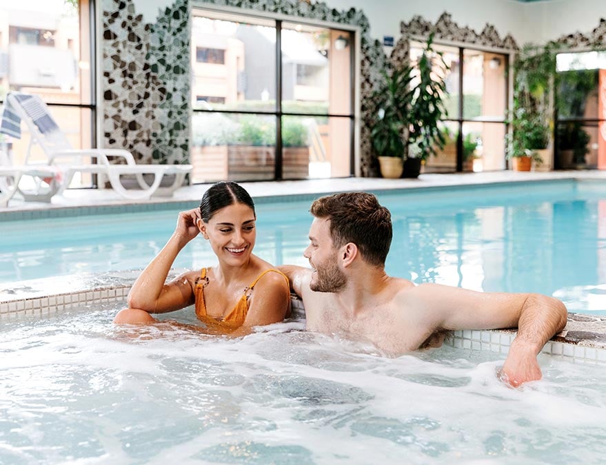 Couple enjoying the pool of a hotel
