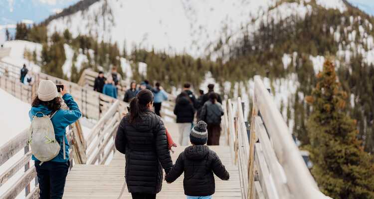 Parent and child walking down steps in the mountains