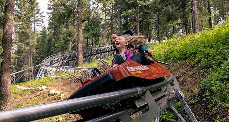 Woman and girl on the Railrider Mountain Coaster.
