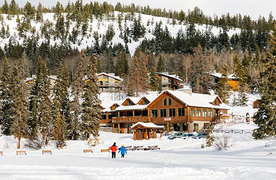 Skaters on a frozen Pyramid Lake with the Lodge in the background.
