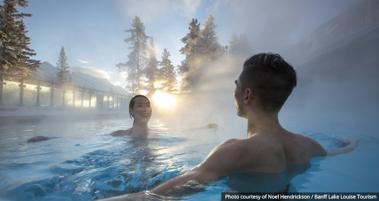 A couple enjoying the Banff Hot Springs in the winter